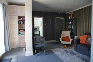 a living room with a couch and a chair at Seaford Snug in Seaford