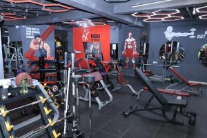 a gym with cardio equipment in a room at Hotel New JMK in Katra