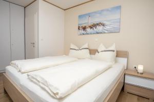 a white bedroom with a large white bed at Beachfront Reiterer Villa V1 with Jacuzzi 30 meters from the Beach - CROWONDER LUXURY RENT in Privlaka