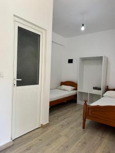 a bedroom with a door and a bed and a window at City & Sea Hideout in Himare