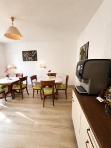 a kitchen and dining room with a table and chairs at Schlösschen am Rhinufer in Alt Ruppin +52 photos