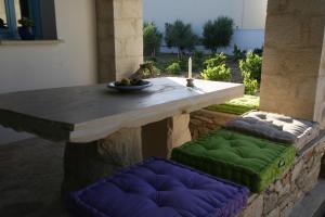 a table and two stools sitting under a table at Villa Antonia in Almyrida