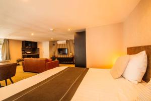 a hotel room with a bed and a living room at Hotel Buren in Buren