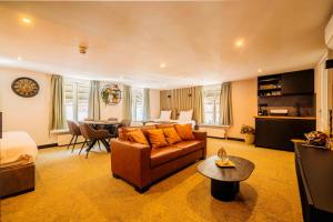 a living room with a couch and a table at Hotel Buren in Buren