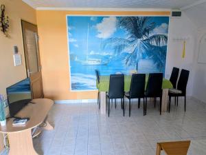 a dining room with a table and chairs and a painting at Hoffman Apartment in Balatonszárszó +14 photos