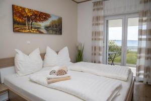 a bedroom with two beds with towels on them at Beachfront Reiterer Villa V3 with Jacuzzi 30 meters from the Beach - CROWONDER LUXURY RENT in Privlaka