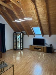a large room with wooden ceilings and a flat screen tv at Loft Fischbach bei Kallmünz 2 Schlafzimmer in Kallmünz