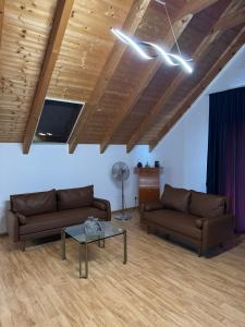 a living room with two couches and a table at Loft Fischbach bei Kallmünz 2 Schlafzimmer in Kallmünz +16 photos