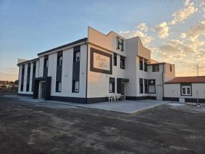 a large white building with a sign on it at H SENDA ReAL in Alcuéscar