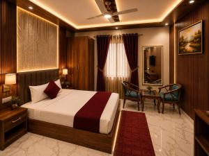 a hotel room with a bed and a table and chairs at Hotel Aura Bellamonts Near Delhi Airport- Free Airport PickUp & Drop , Breakfast & Dinner Complementary in New Delhi