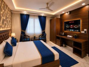 a hotel room with a bed and a television at Hotel Aura Bellamonts Near Delhi Airport- Free Airport PickUp & Drop , Breakfast & Dinner Complementary in New Delhi