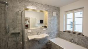 a bathroom with a sink and a shower and a tub at Romantik Hotel Meisenheimer Hof in Meisenheim +73 photos