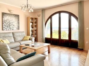 a living room with a couch and a table at Apartments La Perla in Mlini