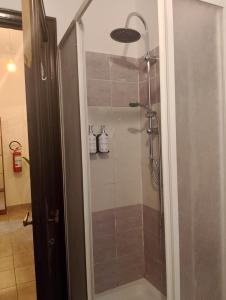 a shower with a glass door in a bathroom at Casa Anna in Ladispoli