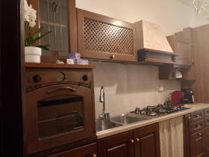 a kitchen with an oven and a sink and a stove at Casa Anna in Ladispoli +10 photos