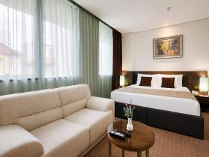 a hotel room with a bed and a couch at Hotel Nartel in Prishtinë +117 photos