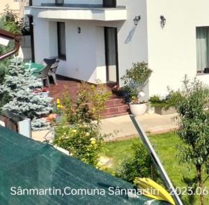 a view of a house with a garden and a house at Bungalow Ildy House in Sînmartin +1 photo