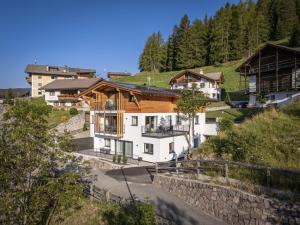 a house in the middle of a mountain at Dosplain Panoramic Apartments in Santa Cristina Gherdëina