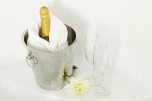 a bucket with a champagne bottle and two wine glasses at hotel le noble in Beirut
