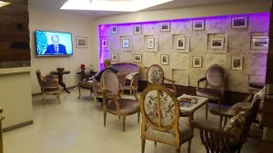 a man sitting at a table in a waiting room at hotel le noble in Beirut