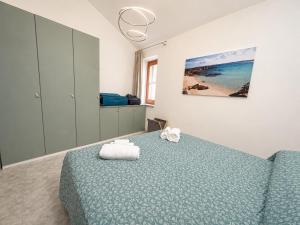 a bedroom with a bed with a blue comforter at ALLOGGIO CASA IN PIETRA in Santu Lussurgiu