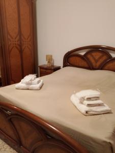 two towels are sitting on a bed in a room at Casa Anna in Ladispoli
