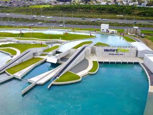 a water park with two slides in the water at Wattle Downs Palm Beach Studio in Auckland
