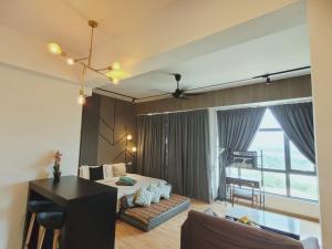 a hotel room with a bed and a living room at Umi Studio Imperium Residence in Telok Baru