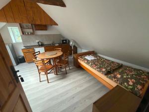 a room with a bed and a table and chairs at Statek u Potoka in Vimperk