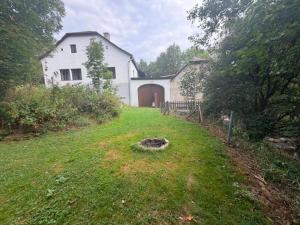 a large white house with a gate and a yard at Statek u Potoka in Vimperk +27 photos