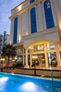 a large building with a pool in front of it at نزل خيال جيزان in Jazan