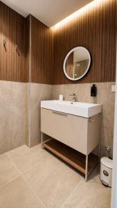 a bathroom with a sink and a mirror at Tirone Luxury Rooms in Cirò Marina +30 photos