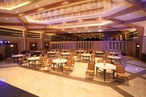 a large banquet hall with tables and chairs at Estrella The Resort in Karjat