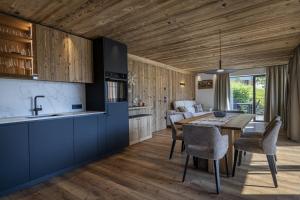 a kitchen and dining room with a table and chairs at Dosplain Panoramic Apartments in Santa Cristina Gherdëina