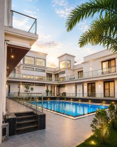 an exterior view of a building with a swimming pool at Estrella The Resort in Karjat