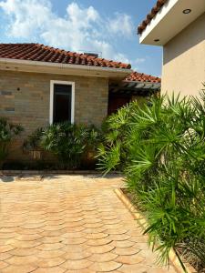 a house with a brick driveway in front of it at Armatyr Motel in Kampala