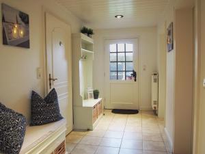 a hallway with a door and a tile floor at Ferienwohnung Austernfischer Ockholm in Ockholm