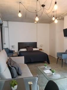 a living room with a bed and a couch at Corredera Travel 2 in Córdoba