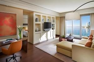 a living room with a couch and a television at Mandarin Oriental Miami in Miami