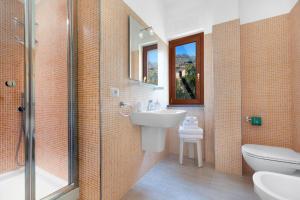 a bathroom with a sink and a toilet and a shower at Rooms Sorrento in Sorrento