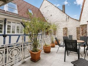 a patio with chairs and a table with plants at Stilhaus 1730 in Königsbach Stein