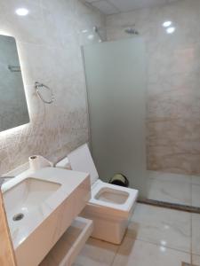 a bathroom with a sink and a toilet and a shower at Wadi Rum Panorama Suites in Disah +243 photos
