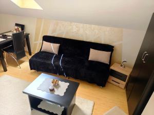 a living room with a couch and a table at Nebeski kutak in Valjevo +27 photos