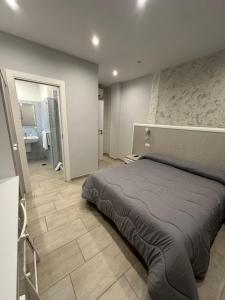 a bedroom with a large bed and a bathroom at Rooms Sorrento in Sorrento