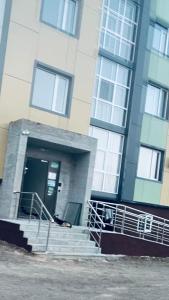 a person laying down in front of a building at ЖК Табигат in Borovoye