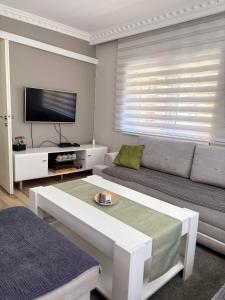 a living room with a couch and a flat screen tv at Deluxe apartment Amar in Sarajevo