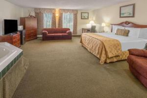 a large hotel room with a bed and a tub at Days Inn by Wyndham Eureka CA in Eureka