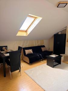 a living room with a couch and a skylight at Nebeski kutak in Valjevo