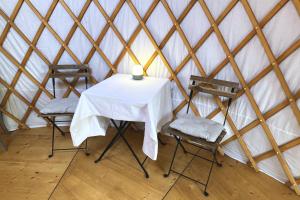 a table and two chairs in a yurt at Yourte pour deux - Voie Bleue in Bayon