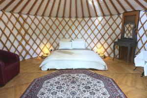 a bedroom with a bed in a yurt at Yourte pour deux - Voie Bleue in Bayon +10 photos